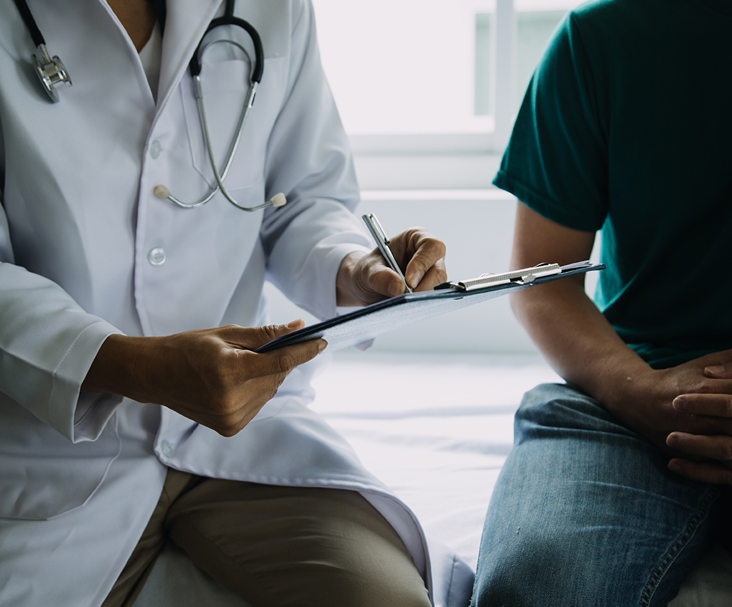 Male patient having consultation with doctor or psychiatrist who working on diagnostic examination on men's health disease or mental illness in medical clinic or hospital mental health service center